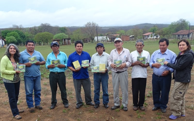 group of Lomerio people standing in a line holding their written books